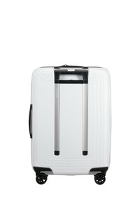 White hard-shell suitcase with textured grooves, black hardware, dual height adjustable handle, and four black wheels for mobility.