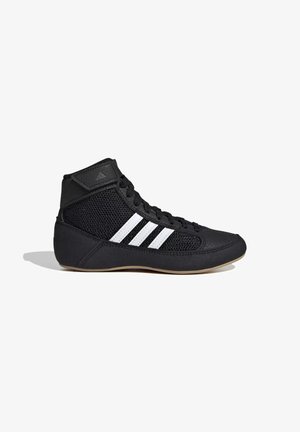 Chaussure de lutte Adidas montante noire avec des bandes blanches, côtés en mesh, avant à lacets et semelle beige.