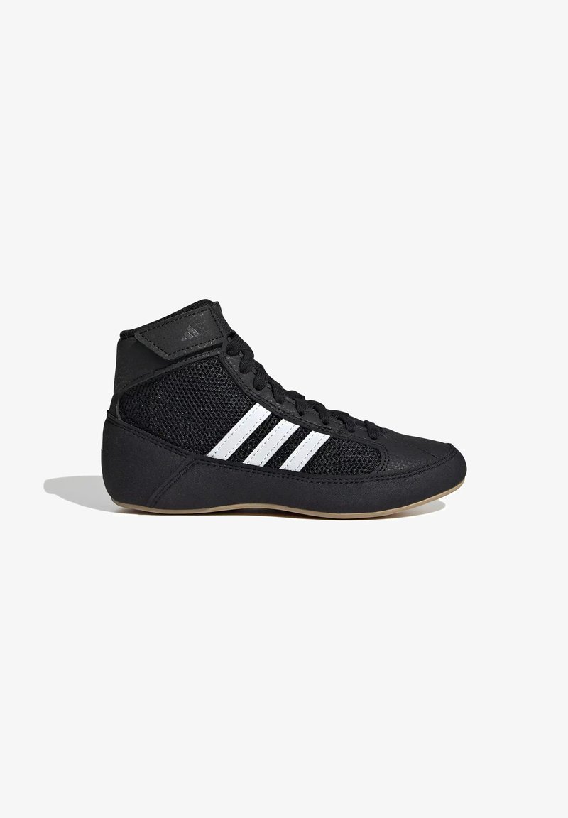 Chaussure de lutte Adidas montante noire avec des bandes blanches, côtés en mesh, avant à lacets et semelle beige.