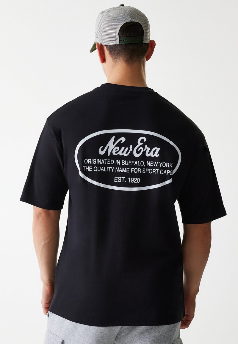 Black T-shirt made of cotton, featuring a large white text print on the back that reads "New Era," with an oval outline and additional text below.