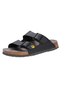 Black sandals with two wide straps, adjustable buckles, cork footbed, rubber sole, and a small yellow logo detail.