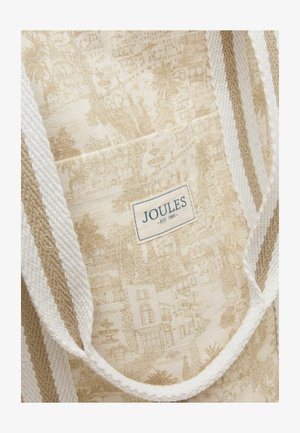 Béžová a biela kabelka tote s pruhovanými rukoväťami a podrobným vzorom toile zobrazujúcim budovy a stromy, označená "JOULES - EST. 1989."