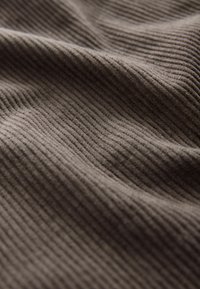 Brown ribbed fabric with a textured surface, showcasing subtle vertical lines and a soft, woven appearance.