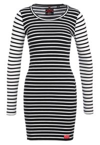 Mustavalkoraidallinen pitkähihainen mekko, jossa on pyöreä pääntie ja vartalonmyötäinen siluetti. Mekossa on pieni punainen etiketti helman kohdalla.