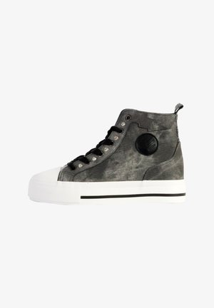 High-top sneaker in gray fabric with white rubber toe cap, black laces, silver rivets, and a circular black logo on the side.