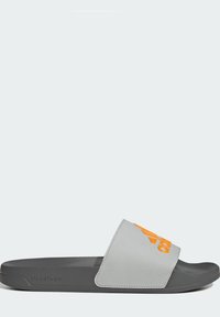 Gray slide sandal with a textured upper, orange logo, and a flat, durable gray foam sole, designed for comfort and casual wear.