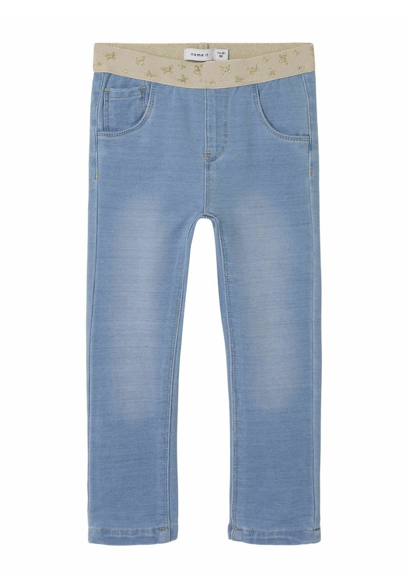 Light blue jeans with a glittery beige elastic waistband, featuring five pockets and a slim fit design. Smooth denim texture with slight fading.