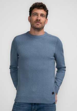 Light blue sweater made of soft fabric, featuring a crew neck, ribbed cuffs, and side detailing. Classic fit with a label at the bottom.