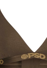 Brun stoff bralette med V-hals design. Har et gull-logo bånd nederst og glatt tekstur uten synlige spenner eller dekorasjoner.