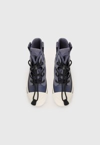 Navy high-top sneakers with a glossy finish, featuring black laces, round eyelets, and a white rubber toe cap. Made of synthetic materials.