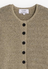 Beige knitted cardigan with six black buttons down the front and a label reading "SCALPERS SPECIAL YARN PLEASE HANDLE WITH LOVE."