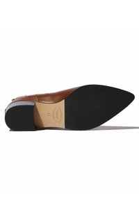 Zapato de cuero marrón con punta afilada y suela de goma negra. Presenta un diseño elegante con un tacón bajo y detalles de estilo minimalista.