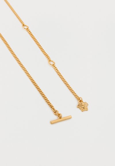 Κολιέ με αλυσίδα σε χρυσούς τόνους με στριφογυριστό σχέδιο, κούμπωμα τύπου toggle και μενταγιόν σε σχήμα ασπίδας.