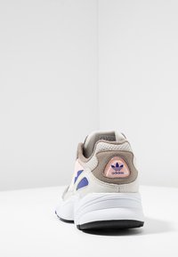 Adidas sneakers med en design i kräm, grå och pastellrosa. Ovandel i mesh, mockadetaljer, vadderad krage och gummisula med logotypdetalj.