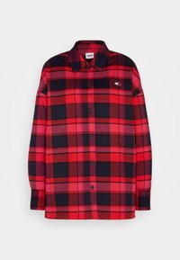 Camicia a quadri rossa e nera, con bottoni, colletto, maniche lunghe e patch logo sul petto. Realizzata in un tessuto morbido con una vestibilità comoda.