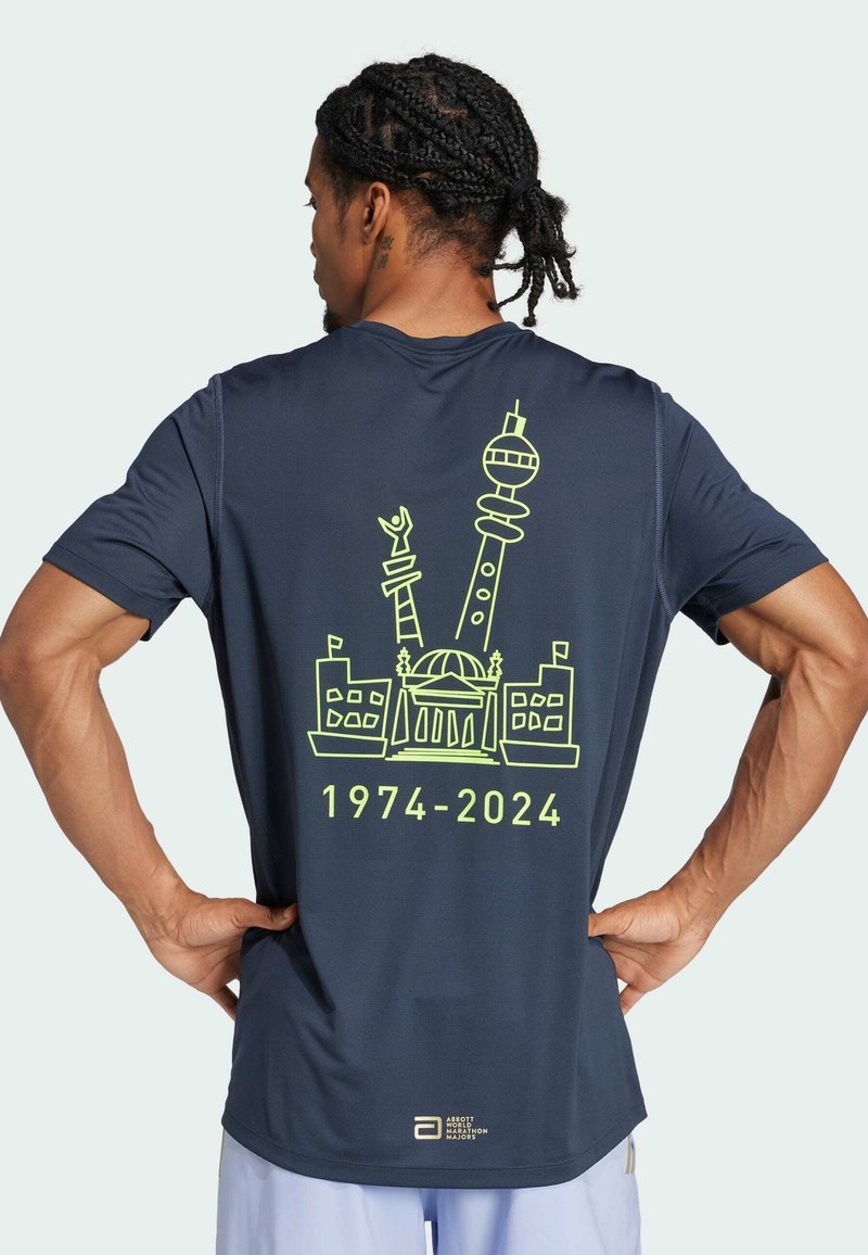 Navy blue athletic t-shirt with short sleeves and a graphic design in neon yellow, featuring landmarks and the text "1974-2024" on the back.