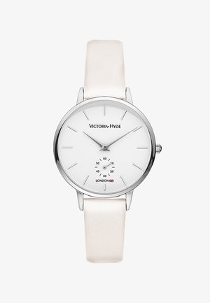 Reloj de pulsera minimalista con esfera blanca, indicadores plateados, marca "Victoria Hyde London", pequeño segundero y correa de cuero blanca.