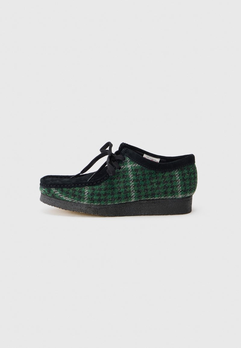 Scarpe verdi e nere con motivo, con una tomaia in suede, presentano una punta arrotondata, lacci e una suola in gomma texturizzata.