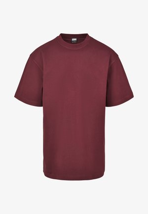 Burgunderfarget bomulls t-skjorte med rund hals, korte ermer og rett kant. Glatt tekstur, avslappet passform, uten mønstre eller detaljer.