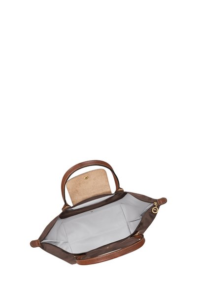 Brown tote bag with open beige flap, spacious gray interior, two handles, and gold zipper pull tab.