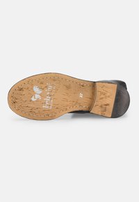 Schwarze Schuhsohle mit einer strukturierten braunen Gummiunterseite. Mit genähtem Rand und Logo-Prägung. Größe angegeben als 37.