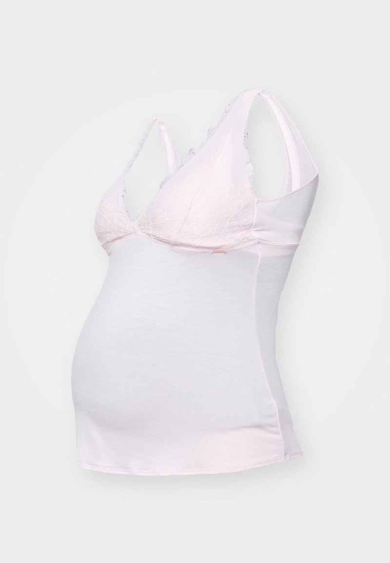 Ροζ μητρική τοπ με δαντέλα στο μπούστο, μαλακό ύφασμα, εφαρμοστό σχήμα, ρυθμιζόμενες τιράντες και λεία στρογγυλή σιλουέτα.