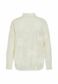 Blouse crème à manches longues avec broderie florale subtile, poignets boutonnés et col montant vue de dos.