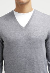 Gray V-neck sweater made of soft fabric, featuring a lightweight knit design, smooth texture, and fitted silhouette.