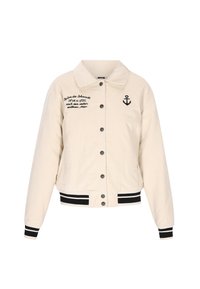 Lys beige kordfløjl jakke med sorte knapper, sort broderi og et ankerlogo. Har stribede manchetter og talje.