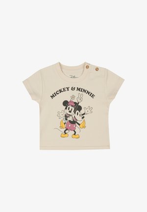 T-shirt en coton beige clair avec un design imprimé de Mickey et Minnie Mouse. Manches courtes avec deux accents de bouton sur l'épaule.