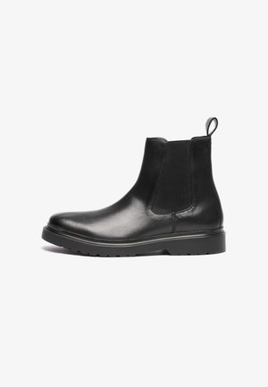 Black leather chelsea boots with elastic side panels, rounded toe, pull tab at the heel, and textured rubber outsole for grip.