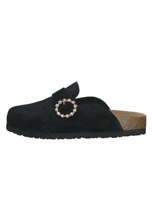Black suede slip-on shoe with a round metal buckle and a cork footbed. The sole is textured for grip. Smooth upper and minimalist design.