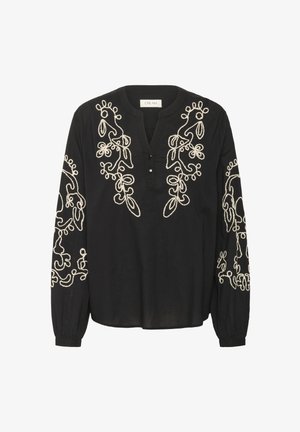 Blouse noire à manches longues avec broderies florales blanches le long des manches et du plastron avant ; possède un col en V et des détails de boutons.