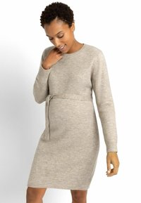 Abito in maglia beige con maniche lunghe, scollatura rotonda e dettaglio con cintura. Tessuto liscio, lunghezza al ginocchio, design casual.
