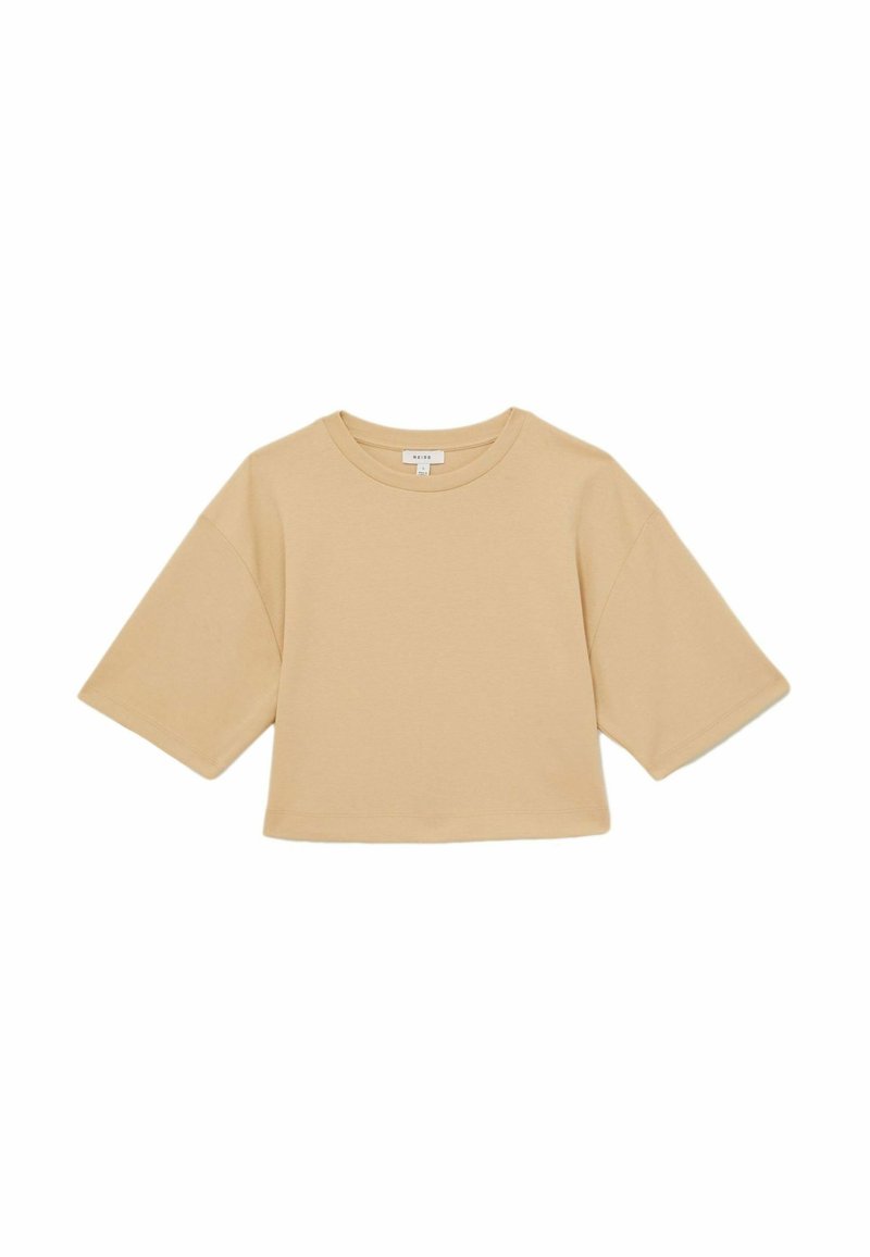 Kortærmet, cropped top i lys beige bomuld. Har en rund halsudskæring og brede ærmer, med en glat tekstur og minimalistisk design.