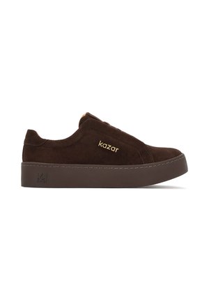 Brown suede sneaker with a thick dark sole, featuring a subtle brand logo in gold and stitched detailing on the upper and sole.