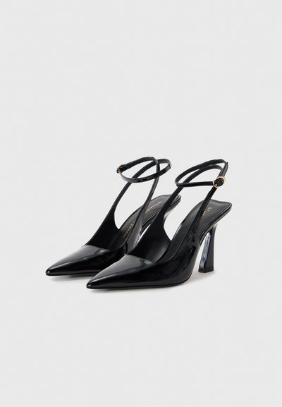 Black patent leather slingback heels with a pointed toe, slender ankle straps, and a curved stiletto heel. Smooth surface and shiny finish.