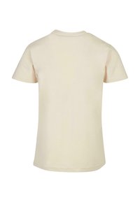 Kortærmet t-shirt i lys beige, lavet af blød bomuld. Har rund halsudskæring og et glat, uprydet bagdesign.