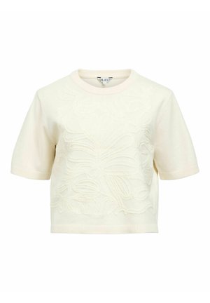 Haut en maille crème à manches courtes avec encolure arrondie et motif floral en relief sur le devant.