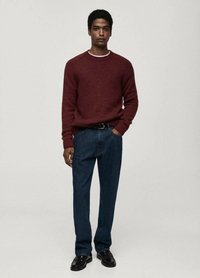 Burgundy knitted sweater with a white collar detail, paired with dark blue straight-leg jeans and black leather shoes. Simple design, textured fabric.