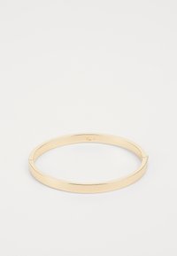 Gold metal bangle with a smooth, polished finish. Features a sleek, circular design with a slight opening for wearing.