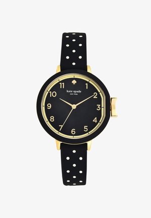 Schwarze und goldene Kate Spade Armbanduhr mit rundem Zifferblatt, goldenen Zahlen, schwarzem Armband mit weißen Punkten und goldener Krone auf der rechten Seite.