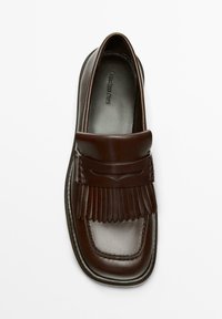 Dark brown leather loafer with fringe detail and rounded square toe, viewed from above on a white background.
