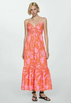 Maxi dress in bright pink with tropical leaf print, featuring spaghetti straps, fitted bodice, and a tiered ruffled hem.