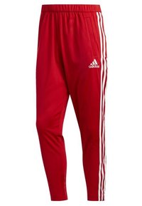 Rode sportieve broek met een taps toelopend ontwerp, elastische tailleband en drie witte strepen langs de zijkanten. Gemaakt van soepel, ademend materiaal.