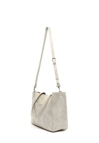 Hall tas, hall nahast disainiga, millel on pikk reguleeritav rihm ja kaks lühikest käepidet. Omab sileda tekstuuri ja minimalistlikke aksessuaare.