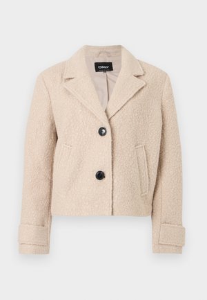 Beige, kurz geschnittene Jacke mit Wollstruktur, mit Reverskragen, zwei schwarzen Knöpfen, Seitentaschen und Manschettendetails.