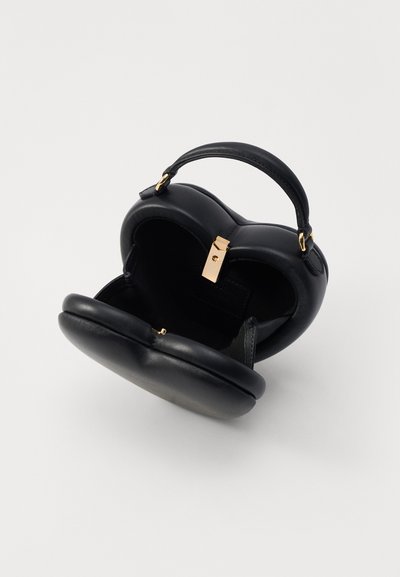 Black heart-shaped handbag made of smooth leather with a small handle, gold-toned hardware clasp, and soft interior lining.