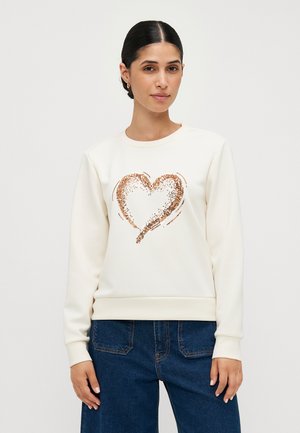 Cream-colored sweatshirt featuring a glittery rose gold heart design on the front, with ribbed cuffs and hem. Smooth fabric texture.