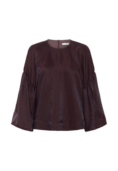 Blouse bourgogne à manches longues avec un col rond, des manches bouffantes et un léger éclat. Dotée d'une fermeture éclair au dos.